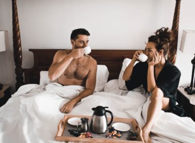 man drinking some coffee beside woman
